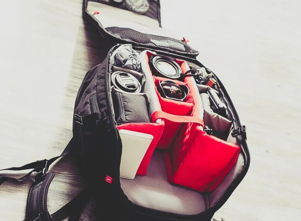 Open backpack with organized gear compartments